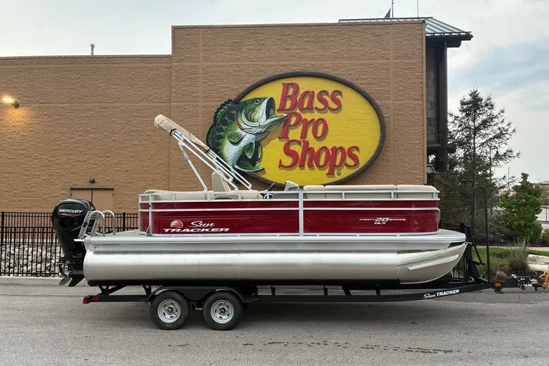 The Image of 2025 Sun Tracker Party Barge 20 DLX pontoon boat outside Bass Pro Shops. - 0