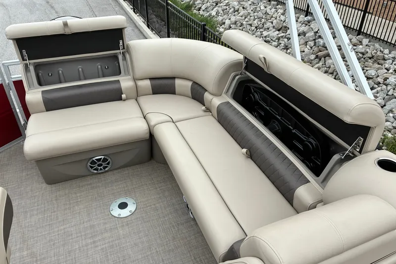 Slide: The Image of 2025 Sun Tracker Party Barge 20 DLX interior with beige seating and storage compartments. - 13