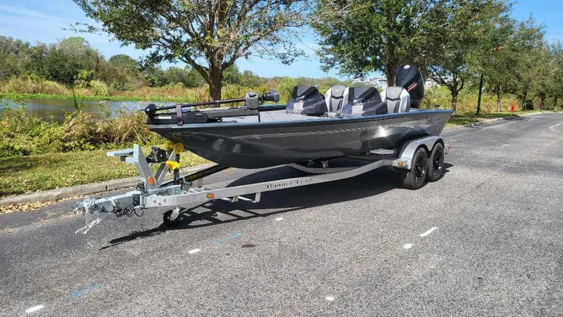 The Image of 2025 Ranger ALPHA 208 boat on trailer, parked on a scenic road. - 0