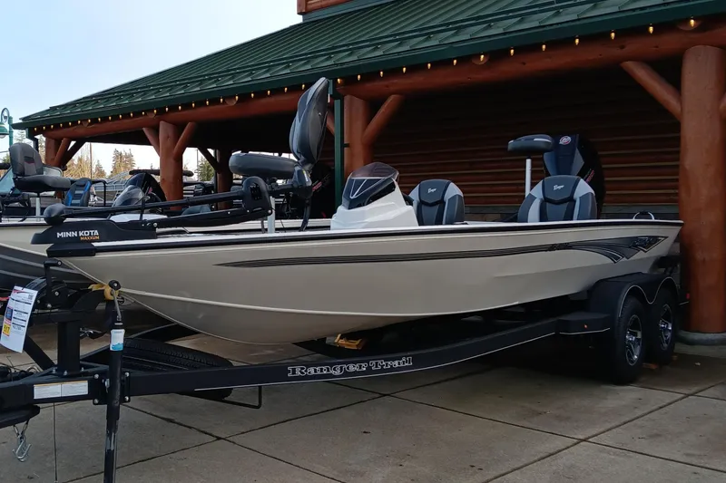 The Image of 2025 Ranger ALPHA 208 fishing boat displayed outdoors on a trailer. - 0