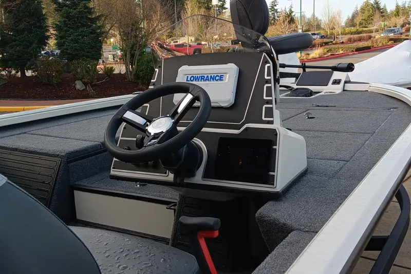 Slide: The Image of 2025 Ranger ALPHA 208 boat interior with steering wheel and Lowrance navigation system. - 2