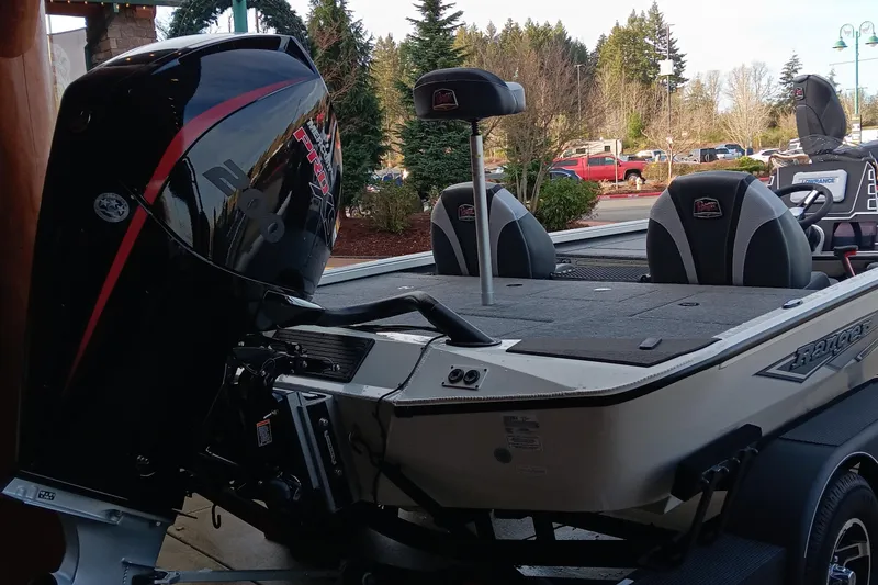 Slide: The Image of 2025 Ranger ALPHA 208 boat with powerful outboard motor, parked outdoors. - 3