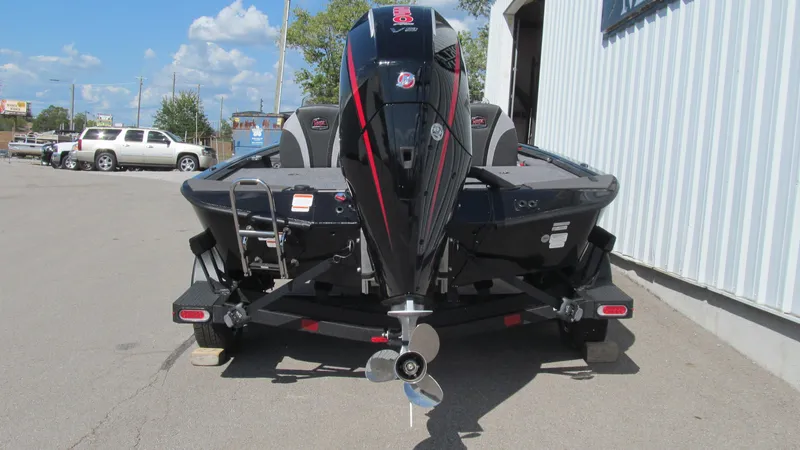 Slide: The Image of 2025 Ranger ALPHA 208 boat on trailer, parked outside a building. - 4