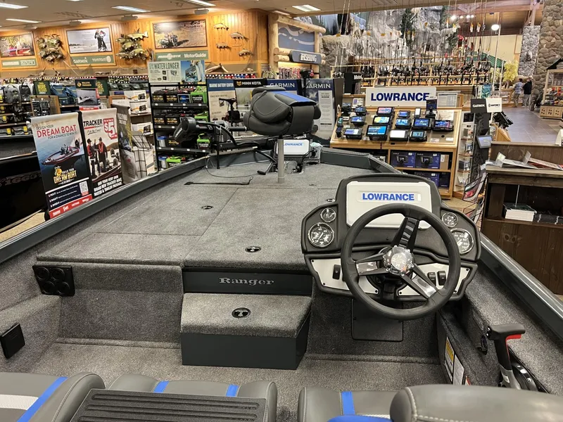 Slide: The Image of 2025 Ranger RT188P boat interior with steering wheel, electronics, and seating in a showroom. - 4