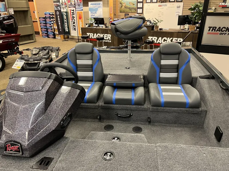 Slide: The Image of 2025 Ranger RT188P boat interior with gray and blue seating in showroom. - 6