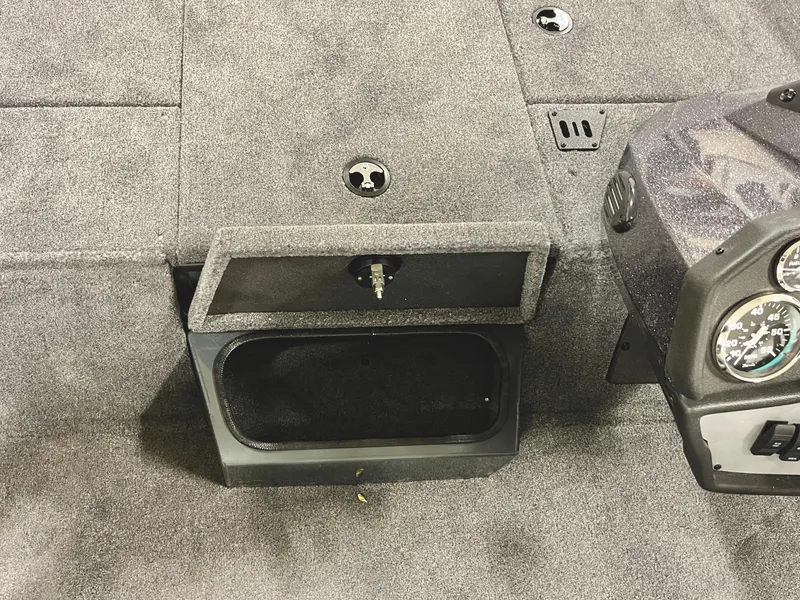 Slide: The Image of 2025 Ranger RT188P boat interior with open storage compartment and dashboard. - 13