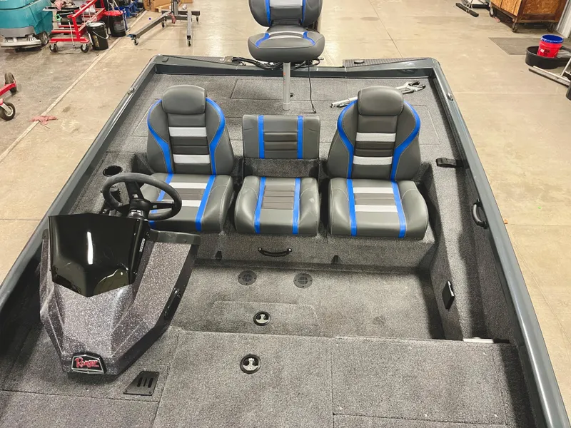Slide: The Image of 2025 Ranger RT188P boat interior with gray and blue seating, steering console, and spacious layout. - 15