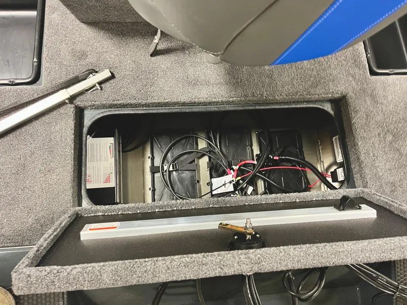 Slide: The Image of 2025 Ranger RT188P boat battery compartment with wiring and storage. - 17
