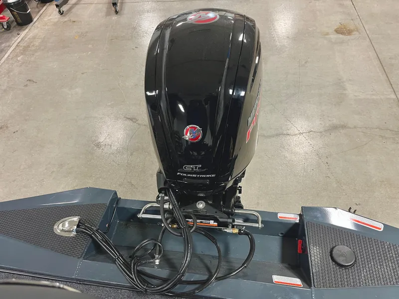 Slide: The Image of 2025 Ranger RT188P boat with a powerful outboard motor, displayed indoors. - 18