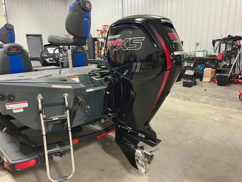 Slide: The Image of 2025 Ranger RT188P boat with Mercury Pro XS outboard motor in a garage. - 5