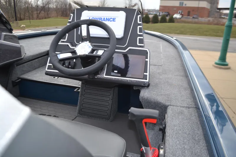 Slide: The Image of Ranger ALPHA 208 boat dashboard with steering wheel and navigation display, 2025 model. - 2