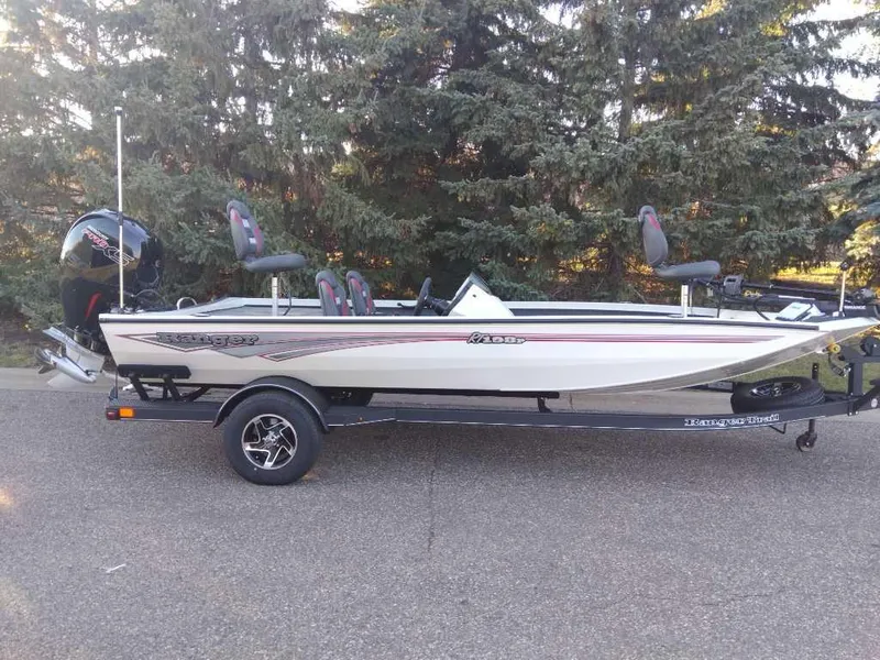 The Image of 2025 Ranger RT198P fishing boat on trailer, parked outdoors. - 0