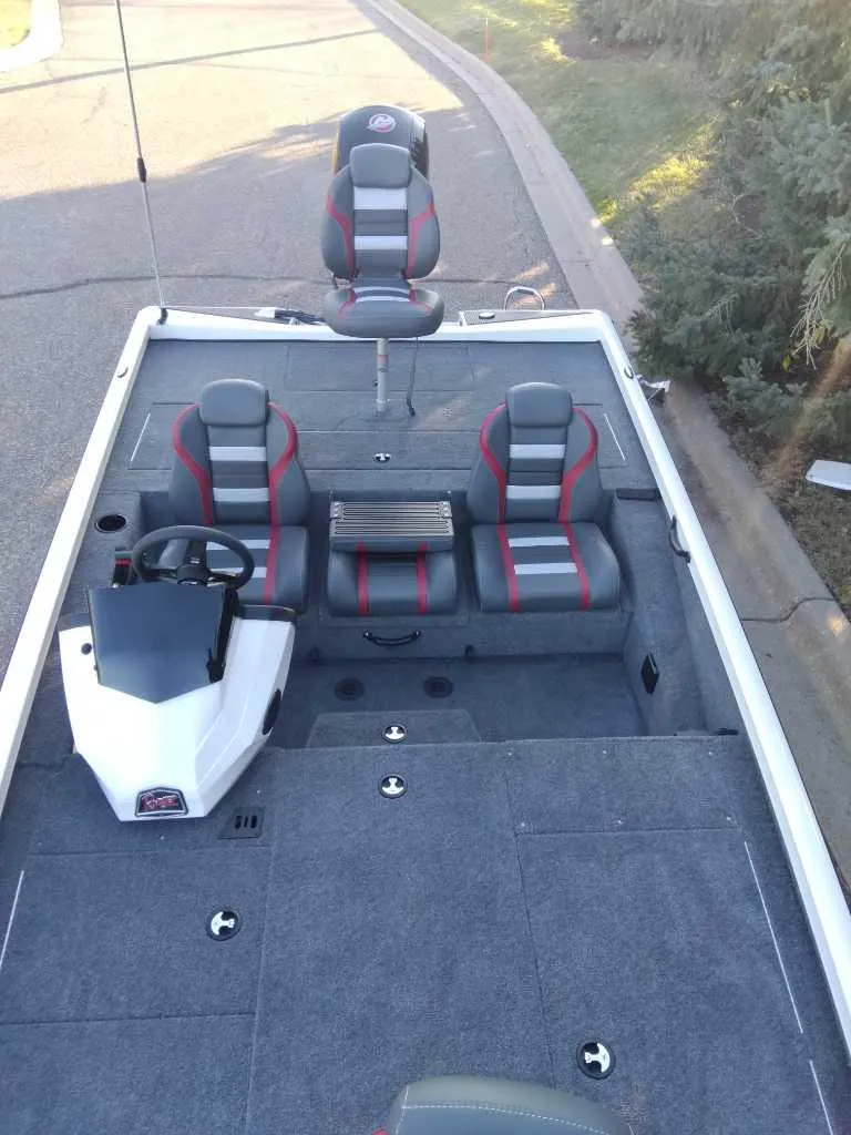 Slide: The Image of 2025 Ranger RT198P fishing boat with dual seats and steering console. - 2