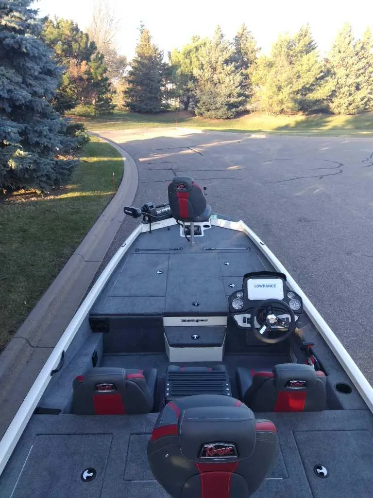 Slide: The Image of 2025 Ranger RT198P boat on a paved road, surrounded by trees. - 3