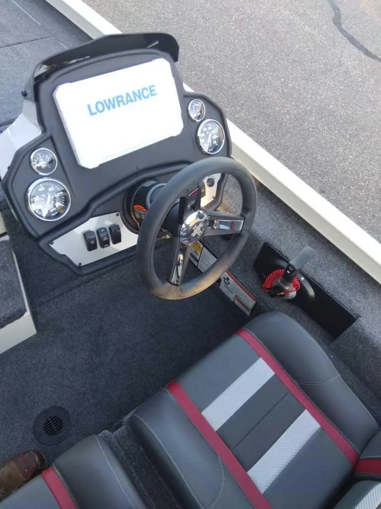 Slide: The Image of 2025 Ranger RT198P boat dashboard with Lowrance display and steering wheel. - 5