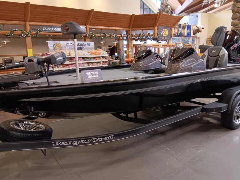 Slide: The Image of 2025 Ranger ALPHA 208 boat on display in a showroom. - 0
