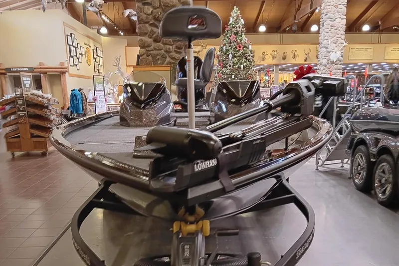 Slide: The Image of 2025 Ranger ALPHA 208 boat displayed indoors with holiday decorations. - 2