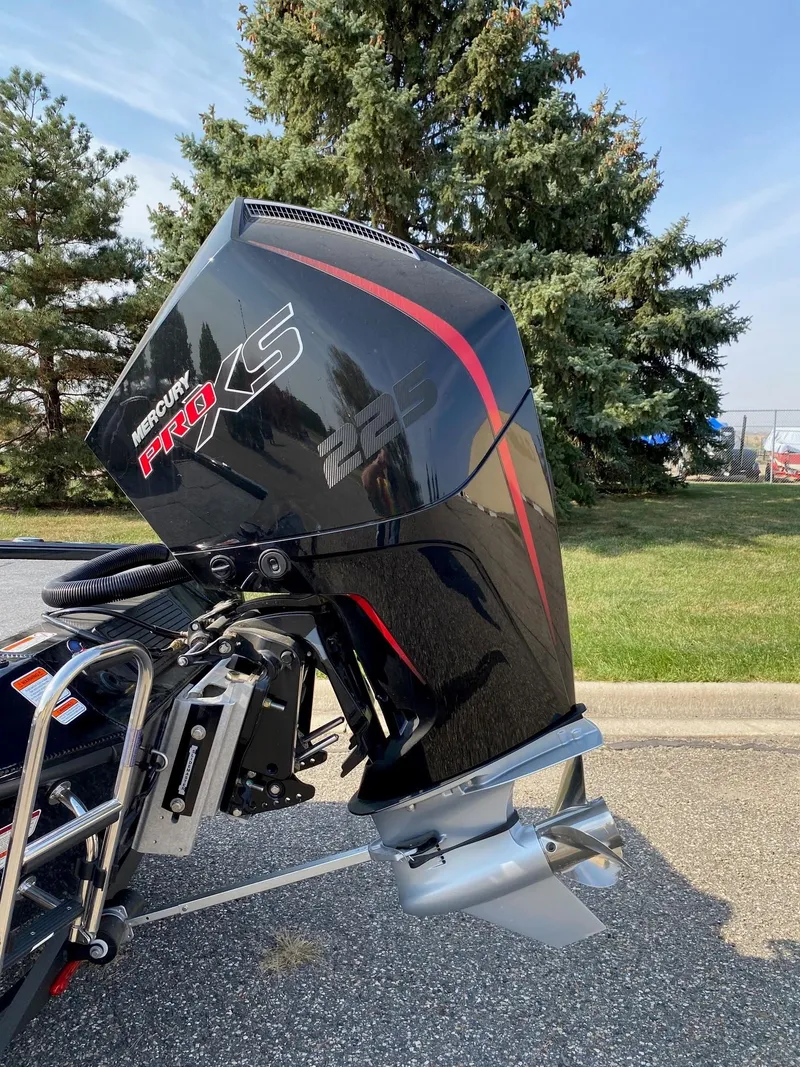 Slide: The Image of Ranger ALPHA 208 boat with Mercury 225 outboard motor, 2025 model, parked outdoors. - 12