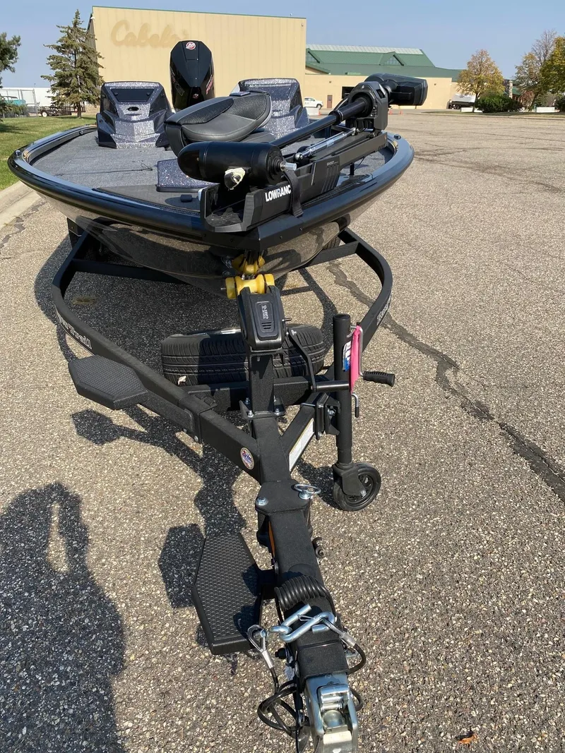 Slide: The Image of 2025 Ranger ALPHA 208 boat on trailer in parking lot. - 13