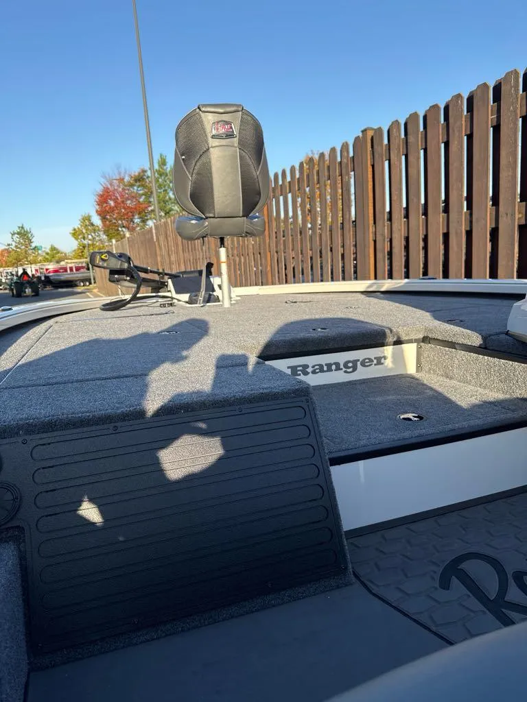 Slide: The Image of 2025 Ranger ALPHA 208 boat deck with seating, against a wooden fence backdrop. - 4