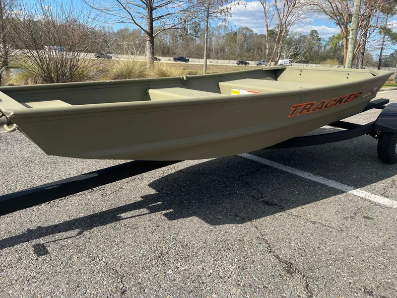 Slide: The Image of 2025 Tracker Grizzly 1036 Utility boat on trailer in parking lot. - 3