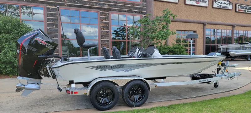 Slide: The Image of 2025 Ranger ALPHA 208 boat on trailer, parked outdoors near building. - 3
