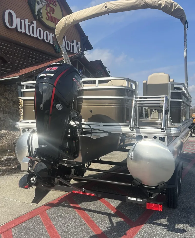 Slide: The Image of 2025 Sun Tracker SportFish 22 DLX pontoon boat parked outside Outdoor World. - 3