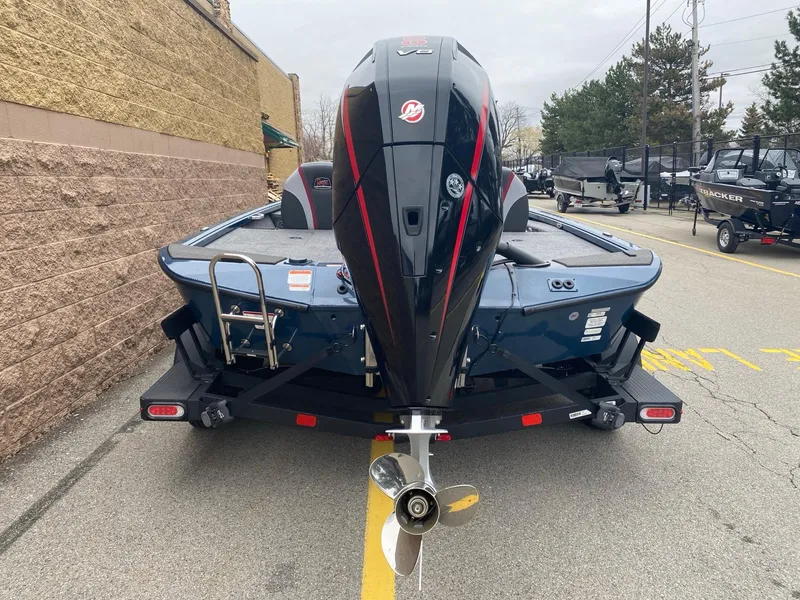 Slide: The Image of 2025 Ranger ALPHA 208 boat, rear view with powerful outboard motor, parked outdoors. - 2