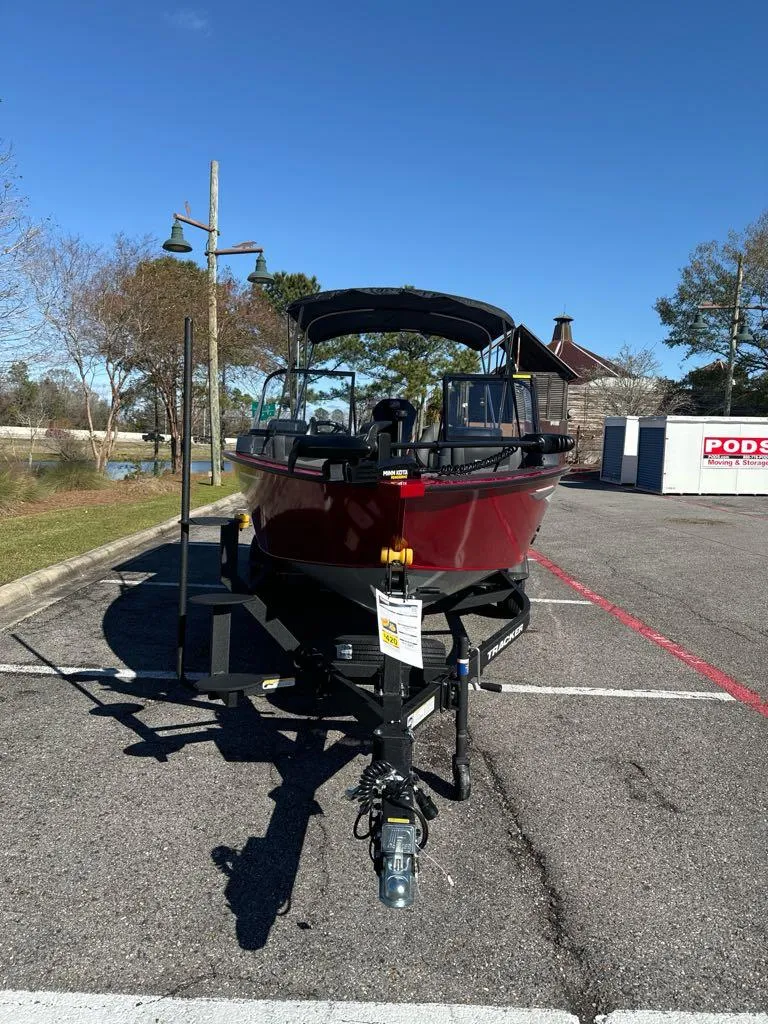 Slide: The Image of 2025 Tracker Targa V-18 WT boat on trailer in parking lot, sunny day. - 3