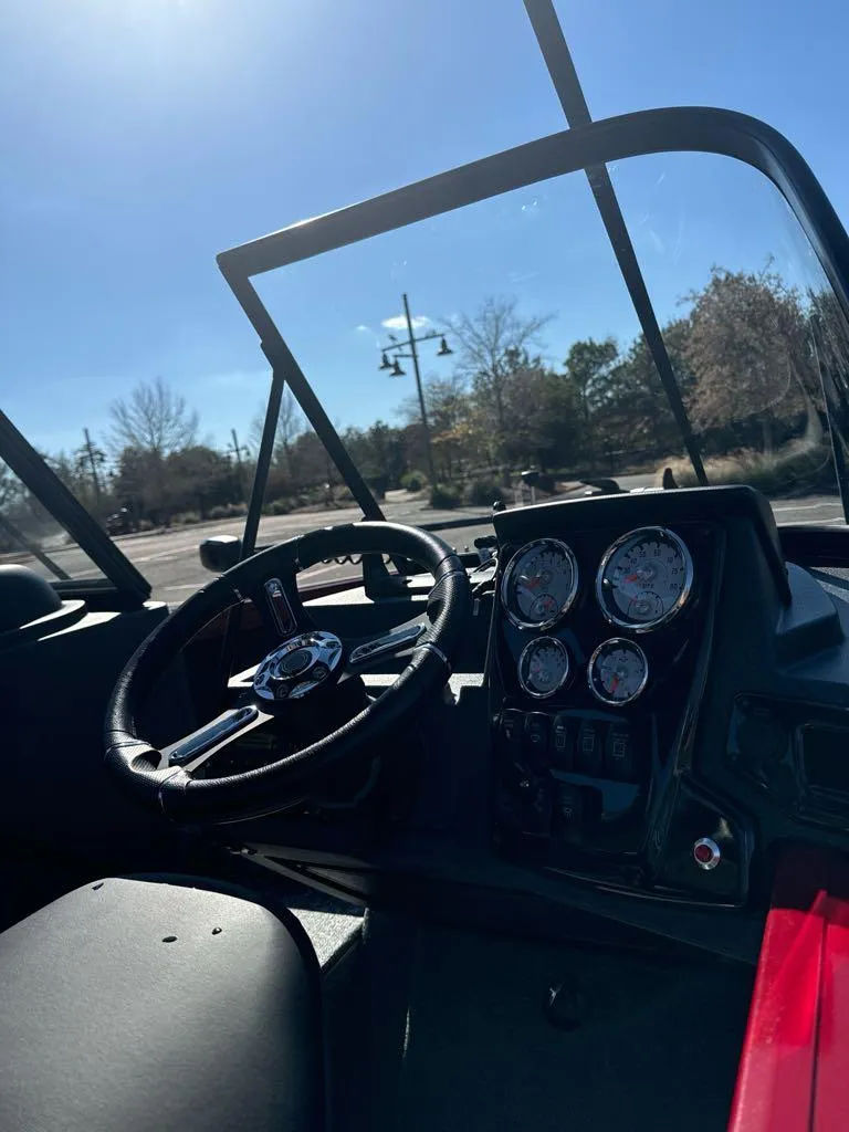 Slide: The Image of 2025 Tracker Targa V-18 WT boat dashboard with steering wheel and gauges. - 7