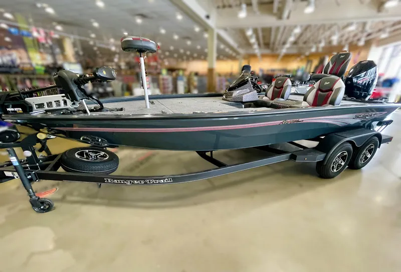 The Image of 2025 Ranger ALPHA 208 fishing boat displayed indoors on a trailer. - 0