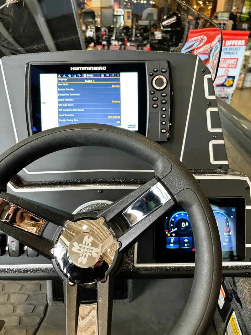 Slide: The Image of Steering wheel and dashboard of 2025 Ranger ALPHA 208 boat with digital displays. - 2