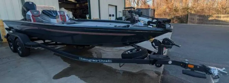 Slide: The Image of 2025 Ranger ALPHA 208 boat on trailer outside a garage. - 3
