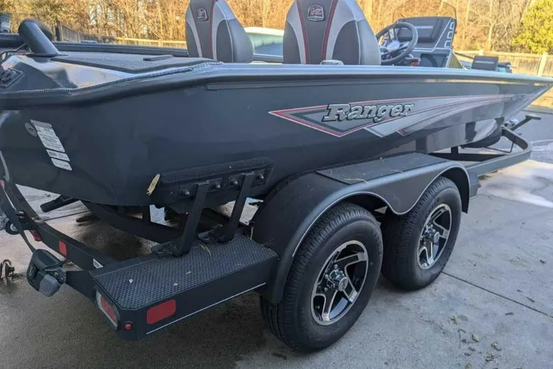 Slide: The Image of 2025 Ranger ALPHA 208 boat on trailer, sleek design, dual axles, outdoor setting. - 4