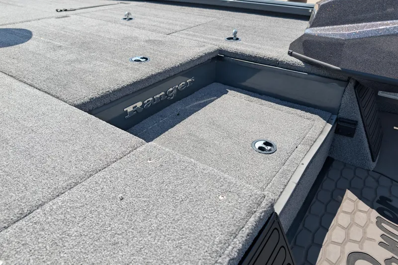 Slide: The Image of Ranger ALPHA 208 boat deck, 2025 model, featuring carpeted storage compartments. - 9