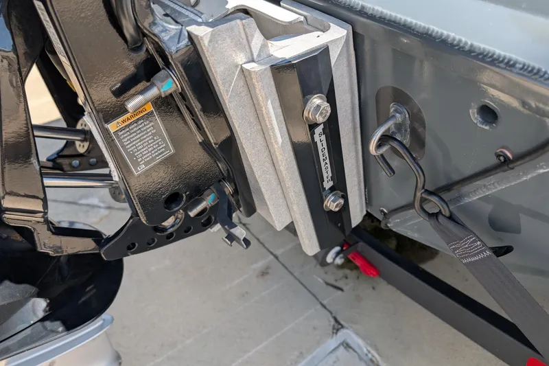 Slide: The Image of Close-up of Ranger ALPHA 208 2025 vehicle component with warning label and secure attachment. - 11