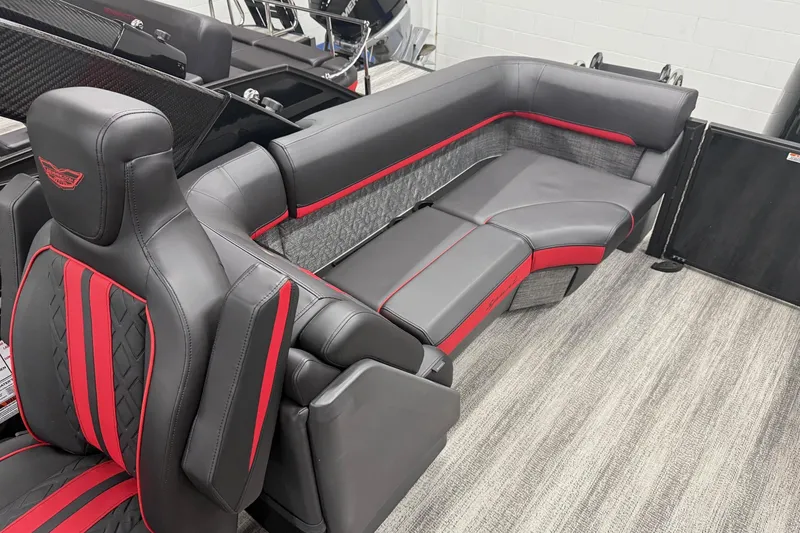 Slide: The Image of Luxurious 2025 Bennington M Line boat seating with sleek black and red upholstery design. - 13