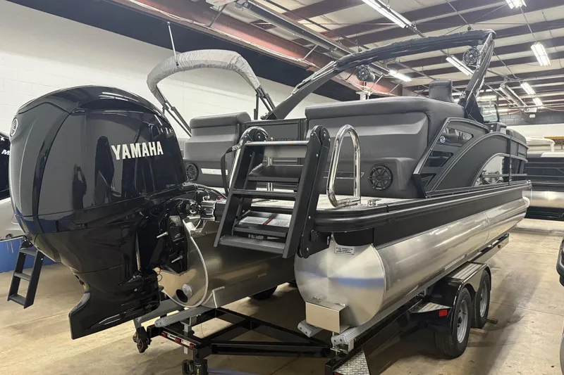 Slide: The Image of 2025 Bennington M Line pontoon boat with Yamaha outboard motor in showroom. - 3