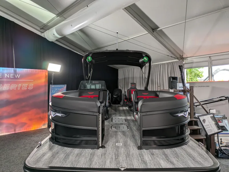 Slide: The Image of 2025 Bennington M Line boat interior with sleek black and red seating design. - 7