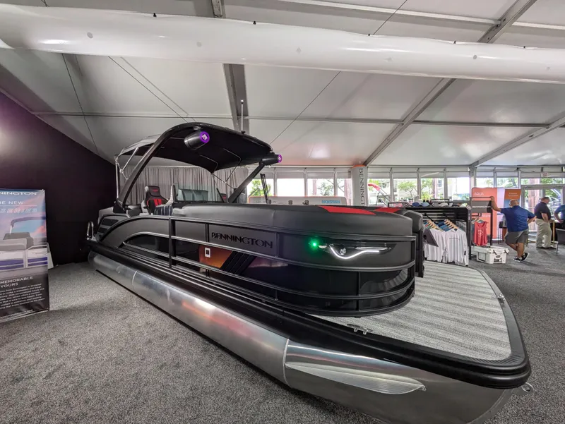 Slide: The Image of 2025 Bennington M Line boat with Yamaha outboard motor in a garage setting. - 8