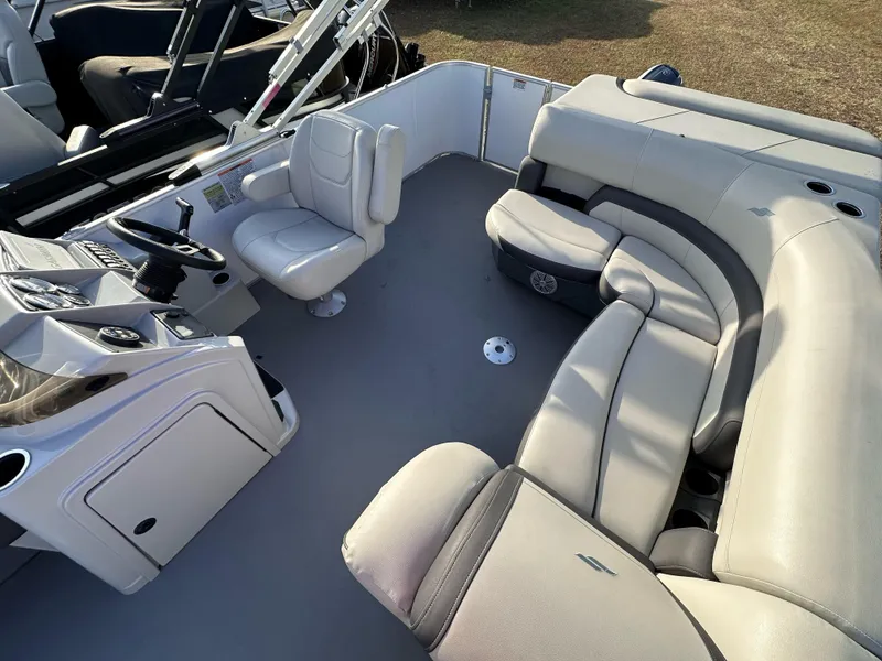 Slide: The Image of 2023 Starcraft EX 20 C boat interior with plush seating and modern helm. - 2