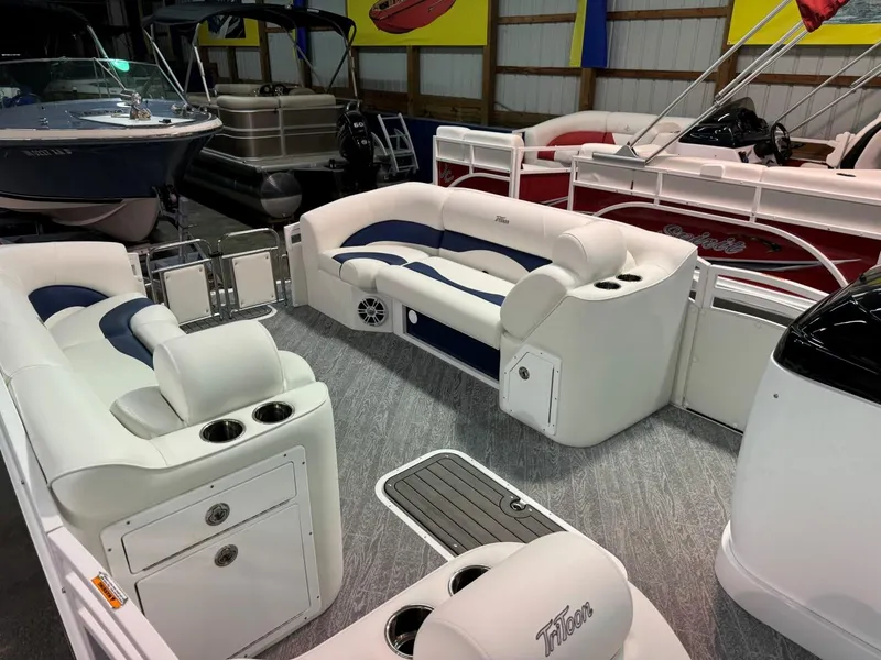 Slide: The Image of 2024 JC Neptoon 23 TT LG pontoon boat interior with white and blue seating. - 15