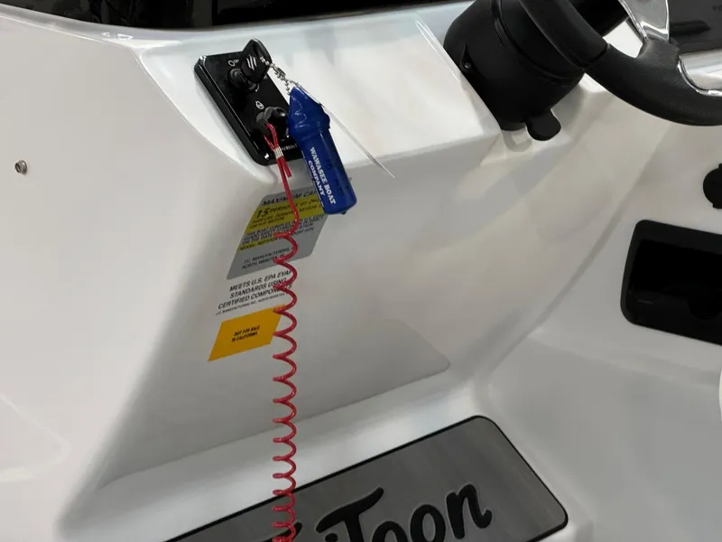 Slide: The Image of 2024 JC Neptoon 23 TT LG boat dashboard with safety lanyard and steering wheel. - 16