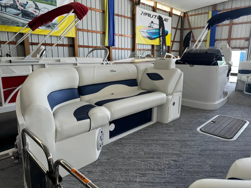 Slide: The Image of 2024 JC Neptoon 23 TT LG pontoon boat interior with plush seating in showroom. - 17