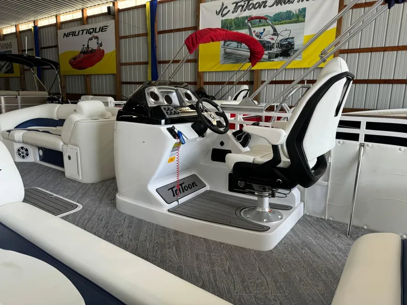 Slide: The Image of 2024 JC Neptoon 23 TT LG pontoon boat interior with captain's chair and control panel. - 19