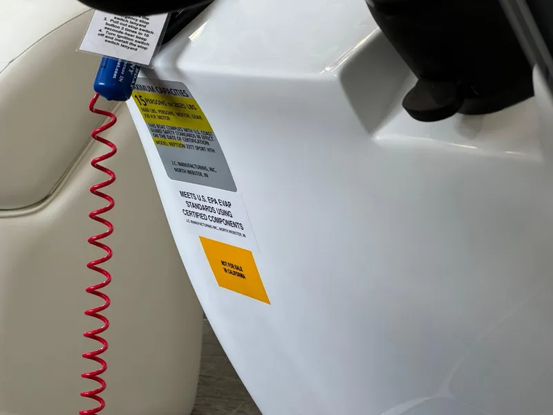 Slide: The Image of Close-up of 2024 JC Neptoon 23 TT LG boat with safety labels and coiled red cord. - 20