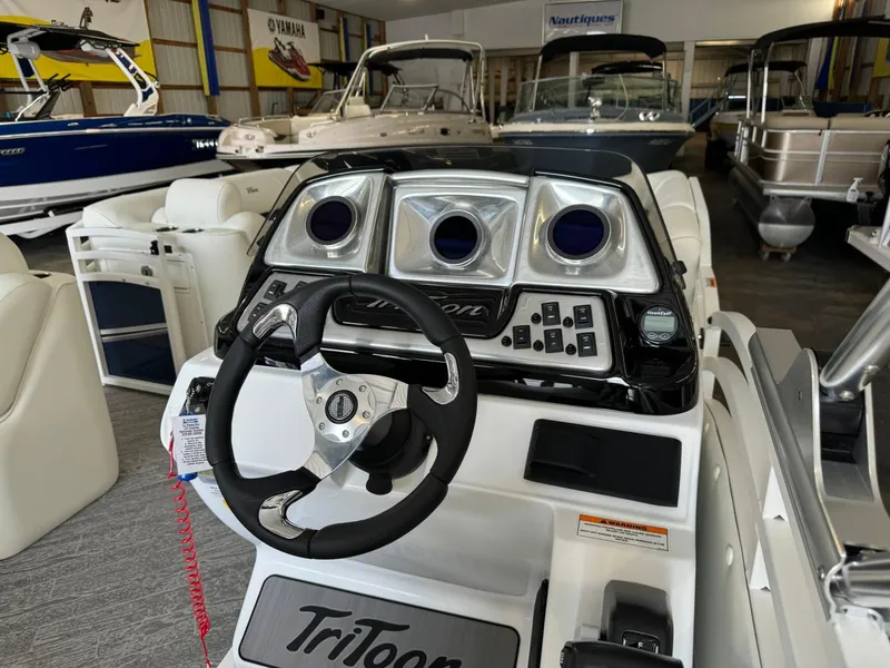 Slide: The Image of 2024 JC Neptoon 23 TT LG boat dashboard with steering wheel in showroom. - 21