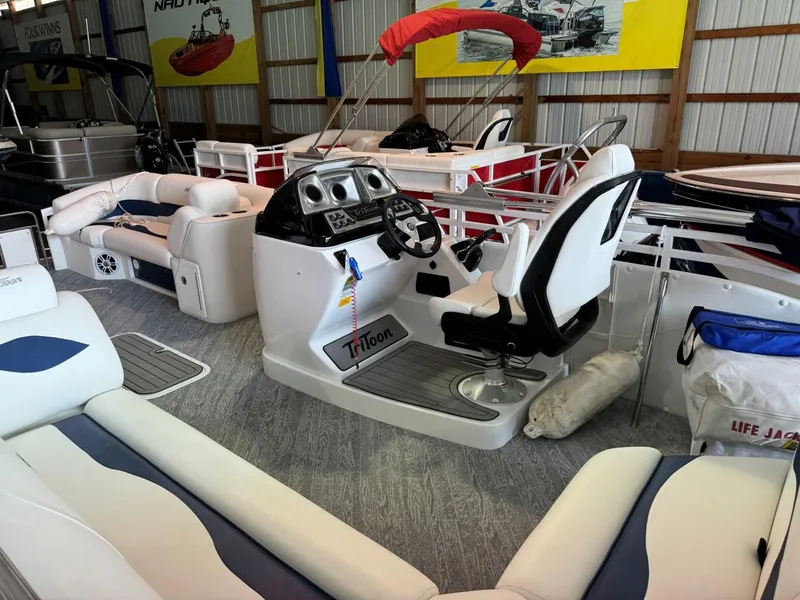 Slide: The Image of 2024 JC Neptoon 23 TT LG pontoon boat interior with steering console and seating. - 5