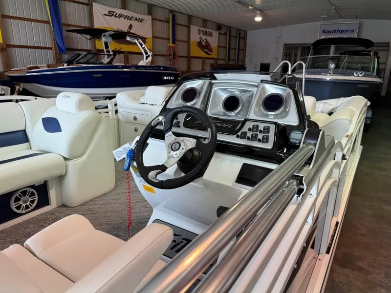 Slide: The Image of 2024 JC Neptoon 23 TT LG boat interior with steering wheel and seating in showroom. - 8