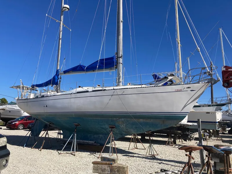 Slide: The Image of 1975 Northstar Hughs Northstar 80/20 sailboat on stands, blue sky background. - 1